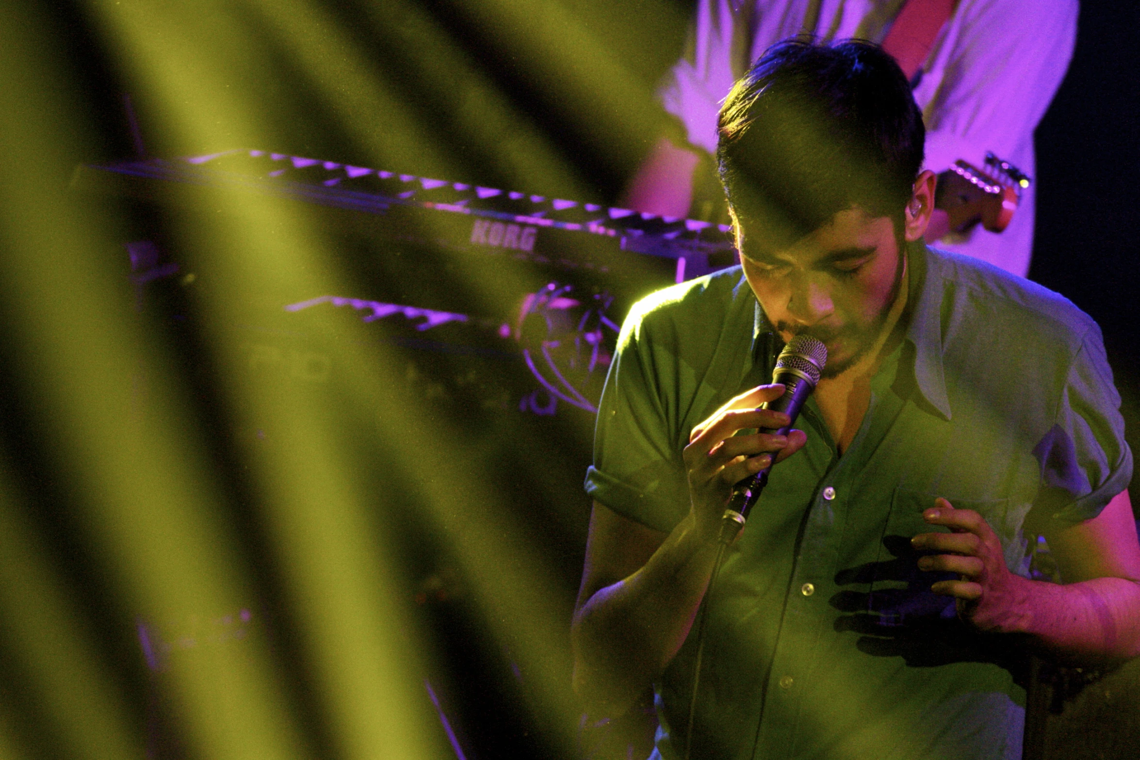 a young man singing on his cellphone with microphone to his ear