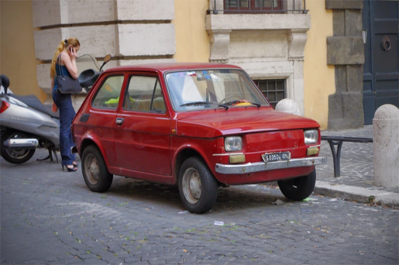 a woman standing next to a car with two bikes