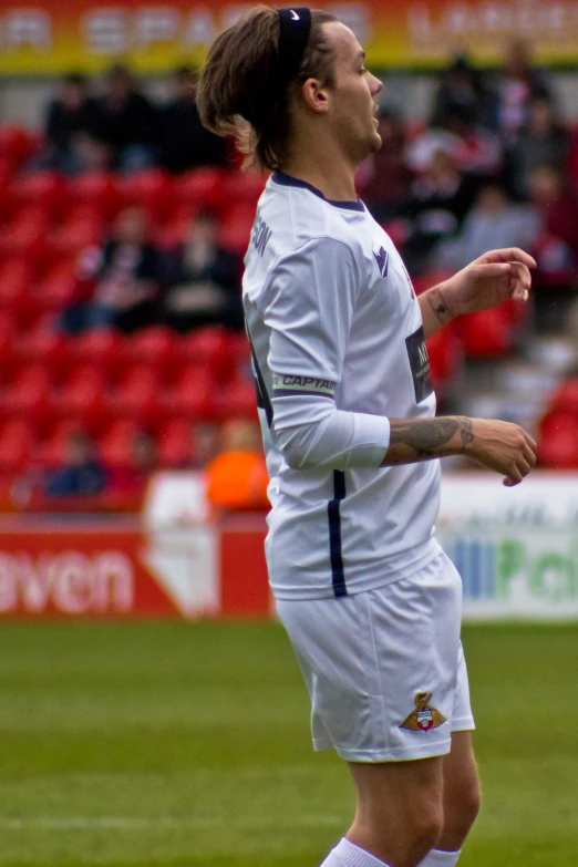 a person standing near a soccer ball on the field