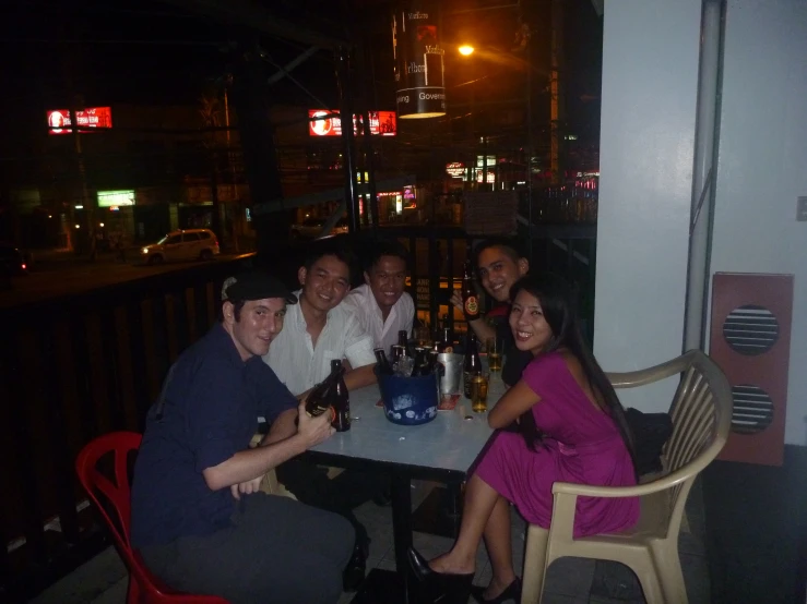 group of people drinking beer at a dinner table