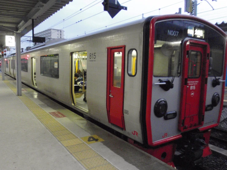 a train in a station next to another train