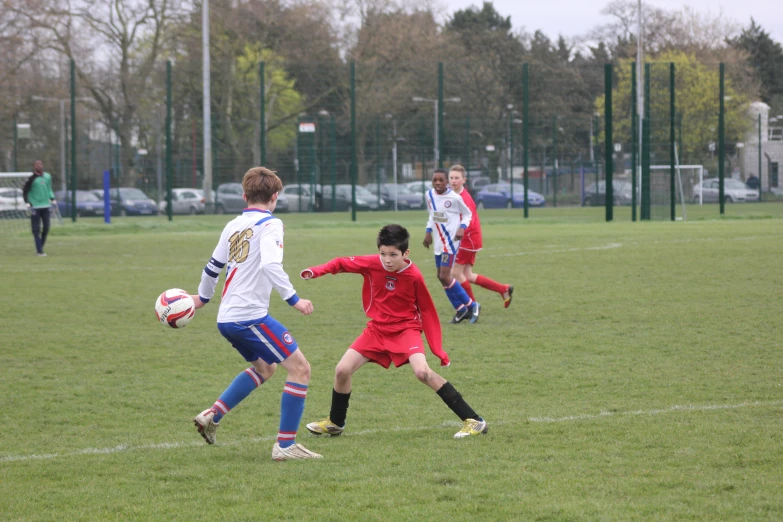 several people in uniform play a game on soccer field