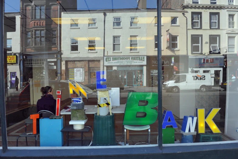 the reflection of people in the window of a building