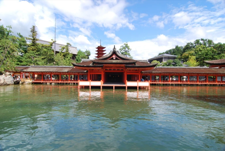 a water area near some trees and buildings