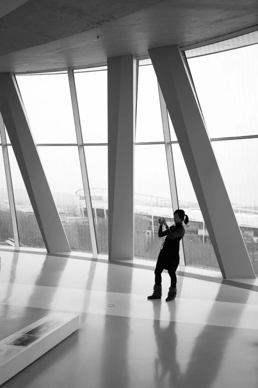 a man taking a picture of himself in a huge building