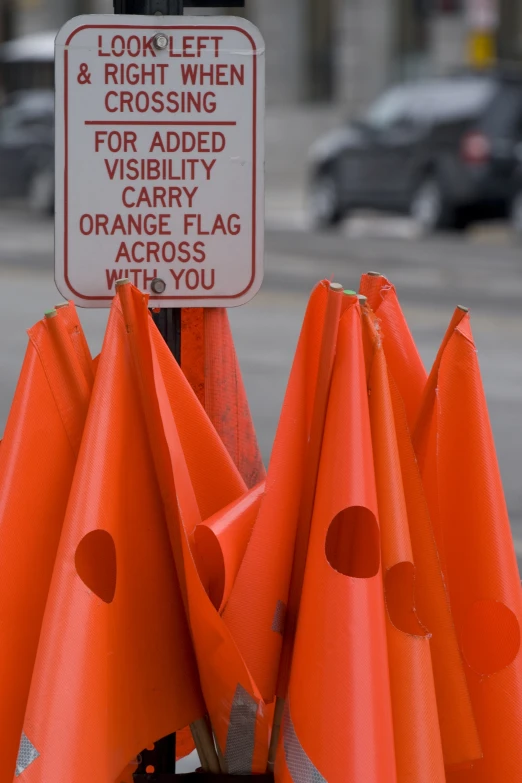 orange cones and a sign that warns drivers of possible dangers