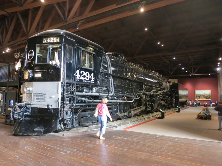 a  standing next to a train on display