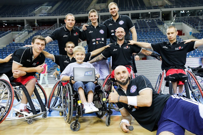 a group of men standing around each other with wheelchairs