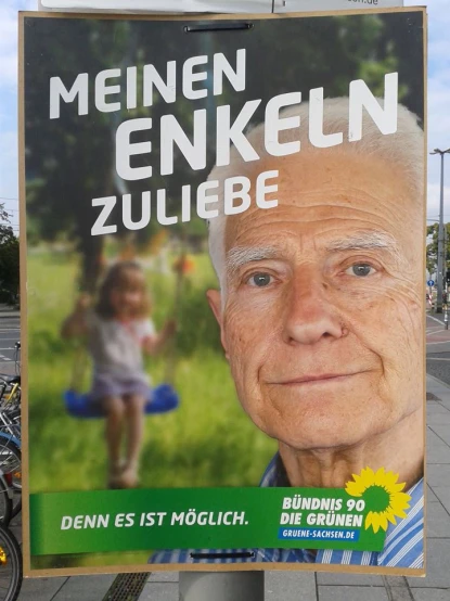 a poster on a pole advertising the birth of an elderly man