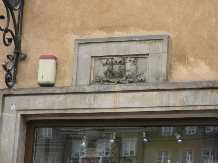 two decorative animals on a brick face on an old building