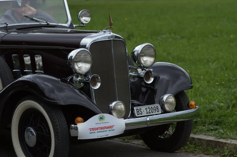 an antique automobile parked in front of the park