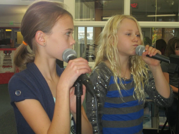 the two s are singing into microphones