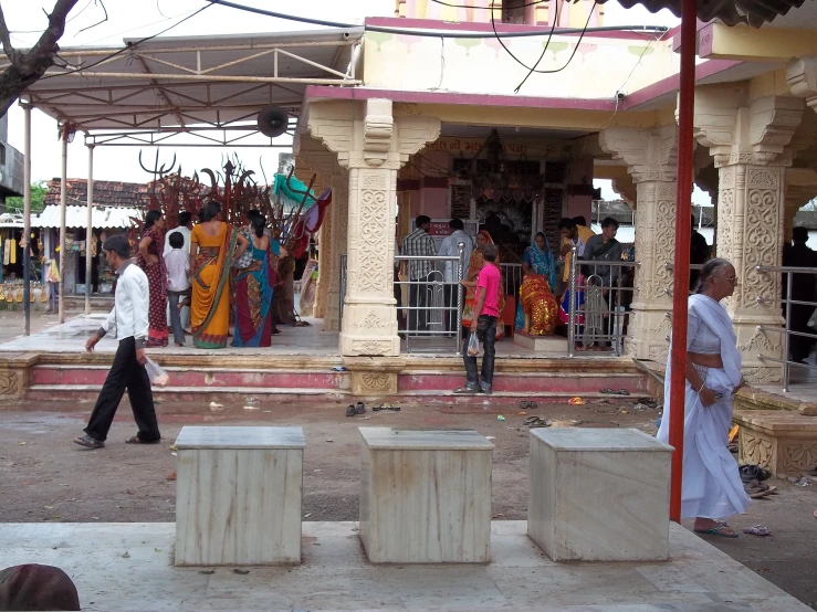 people walking past a group of decorated houses