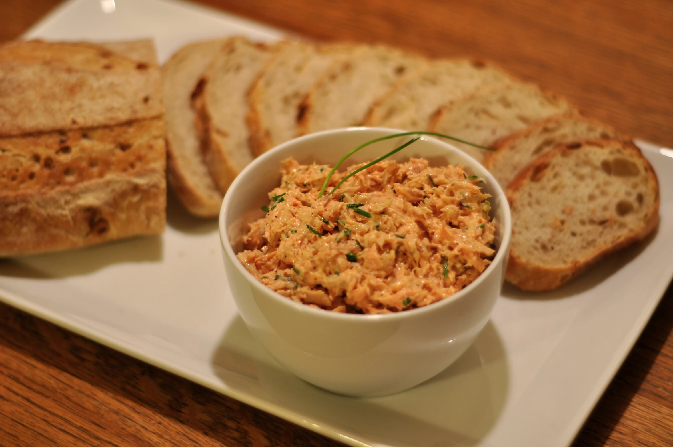 this is an image of some bread and a bowl of tuna