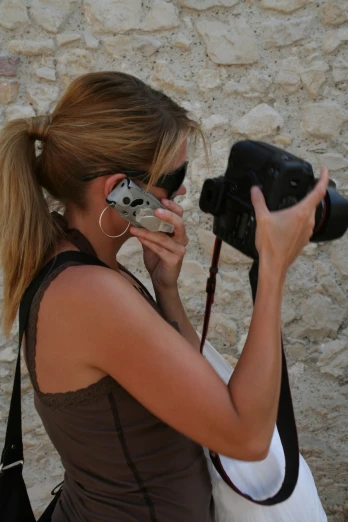 a woman holding up a camera to take a picture