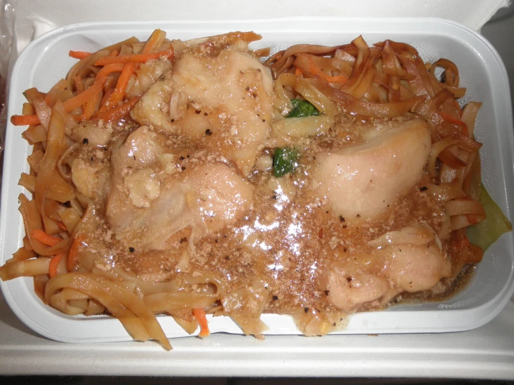 a plastic tray with some chicken and vegetables