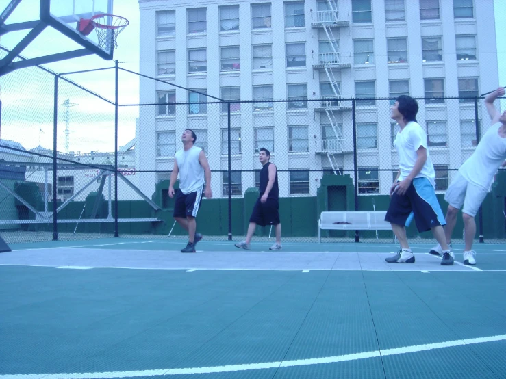 a group of men play basketball on a court