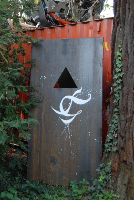 an outhouse has an arrow on it and graffiti