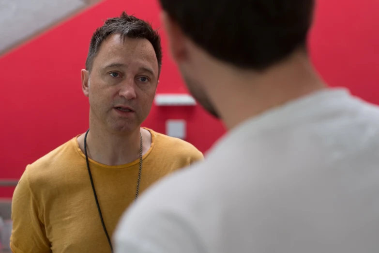 man making a point during discussion with others