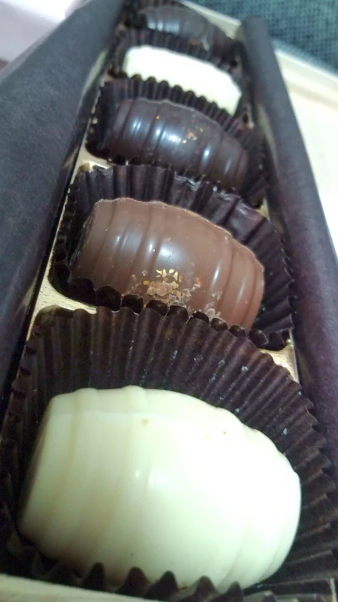 a close up of chocolates in a box