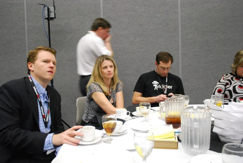 people sitting around a table in business attire