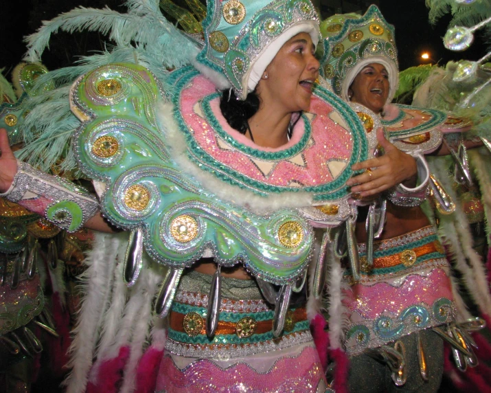 people dancing at an event at night with many in elaborate costumes