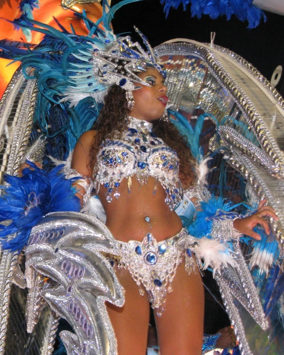 a woman in a silver and blue costume