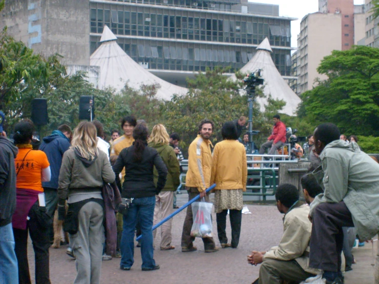 there are people gathered in the street next to each other