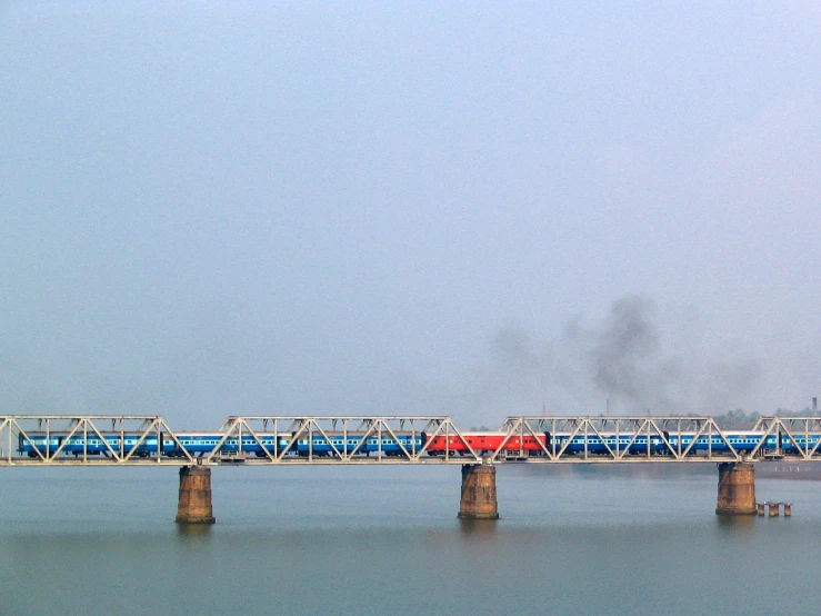a large bridge over water with a train on it