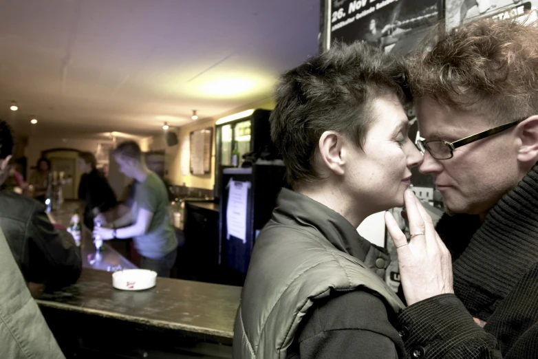 a couple of people standing near a counter