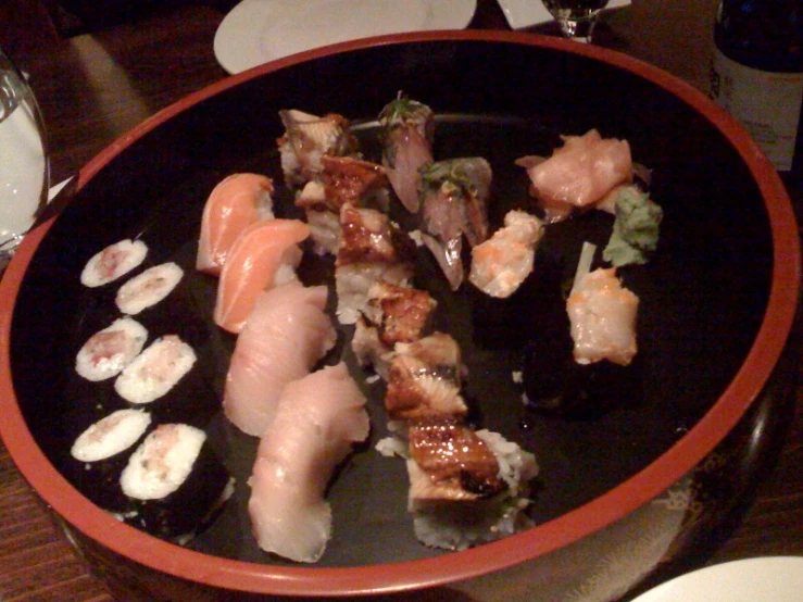 several sushi is shown on a black plate