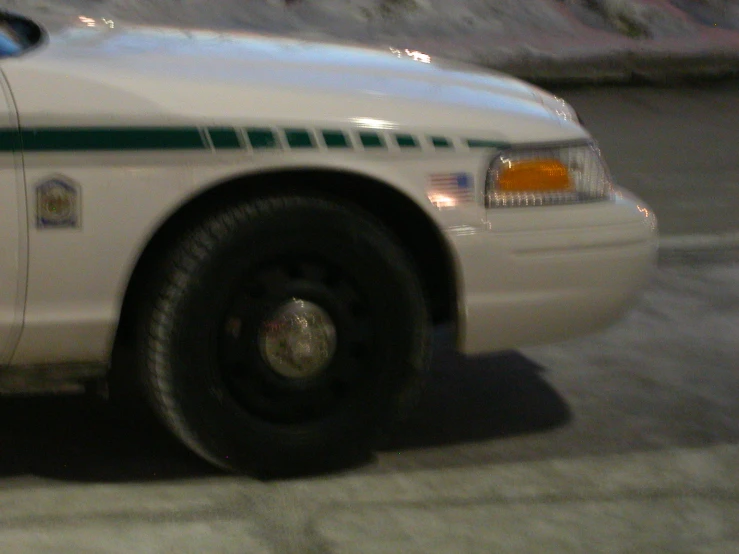 a white police car parked on the side of a street