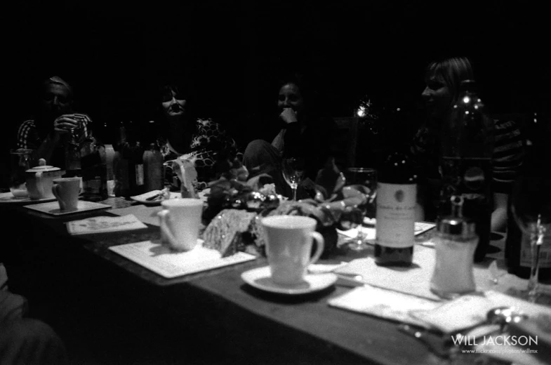 several people are sitting at a table eating