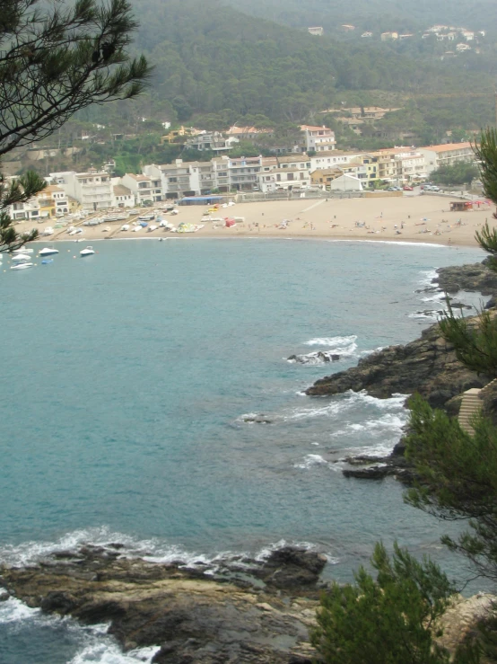 a city beach with a group of boats floating on the water