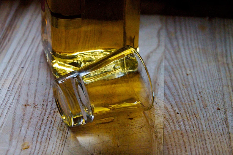 a glass filled with liquid sitting on top of a table