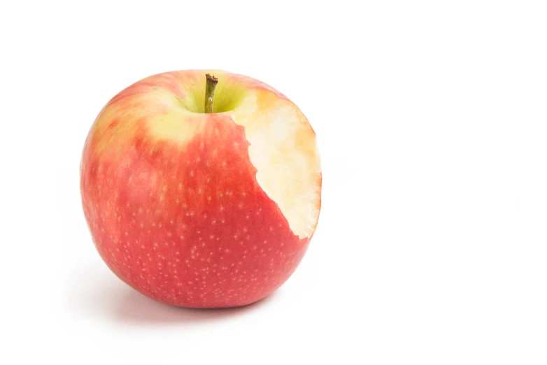 a half eaten red apple against a white background