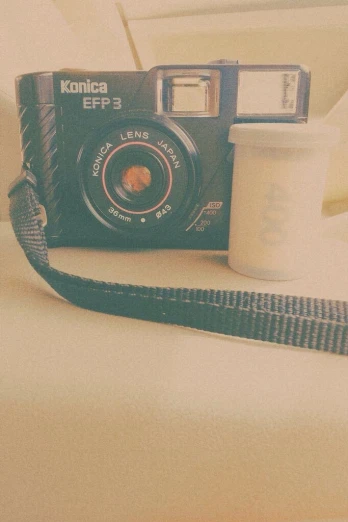 an image of a camera and coffee sitting on the bed