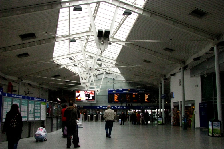 a bunch of people are walking through an airport