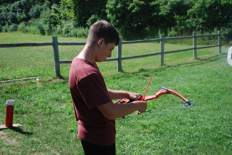 a young man in red shirt preparing to go kite surfing