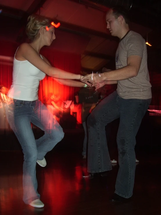 two people standing in front of a red light