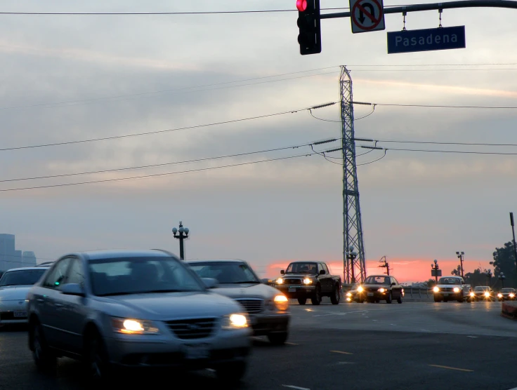 a street filled with cars sitting under traffic lights