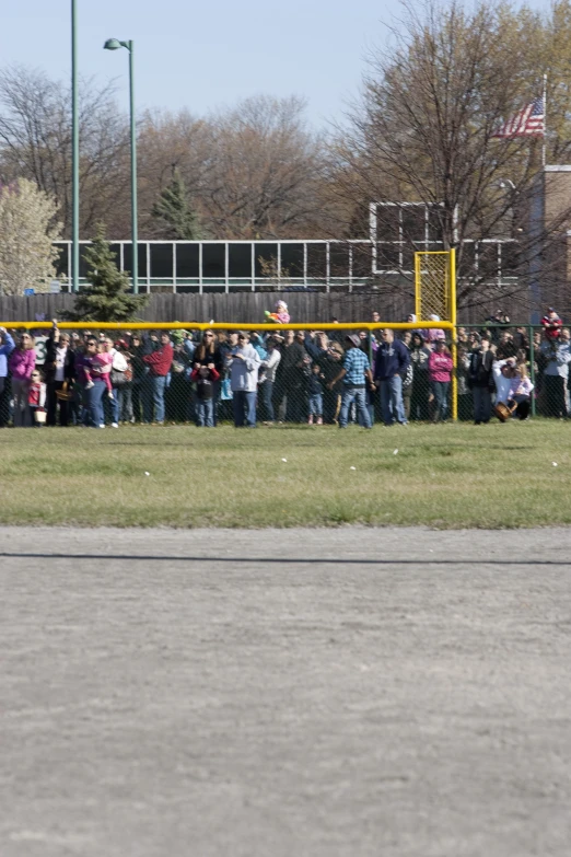 the crowd watches as some play soccer