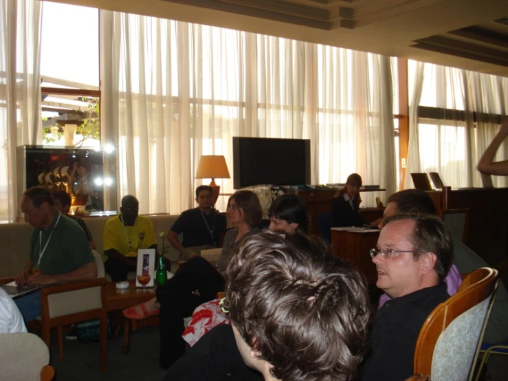 a group of people sitting down in chairs