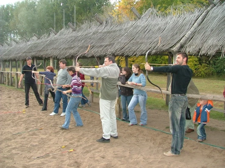 a group of people with an arrow aiming at soing