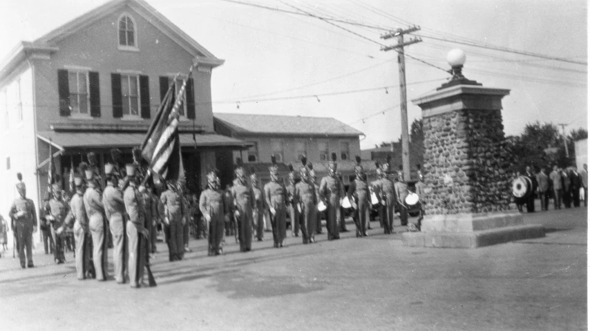 a group of soldiers march in front of an old building