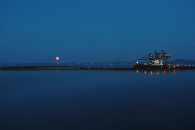 a large ship in the distance on a clear night