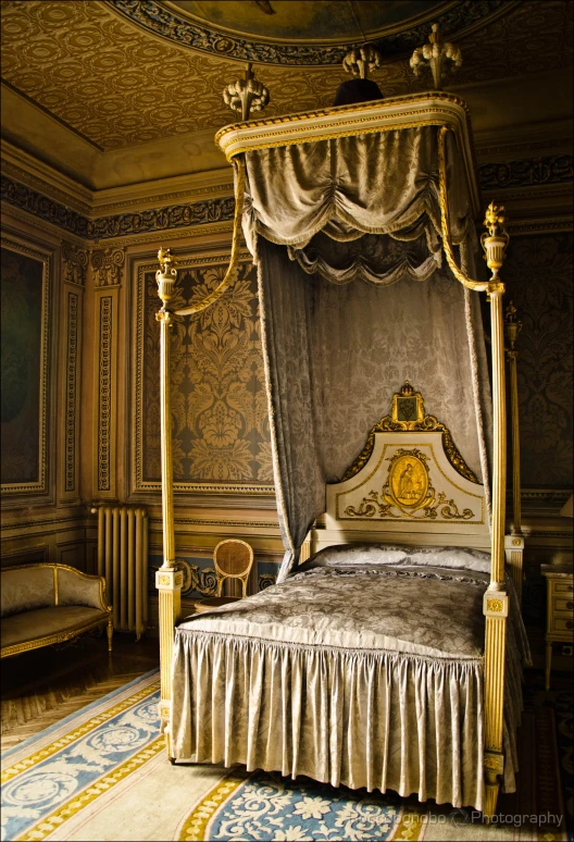 a large, ornate bed is set up in a lavish bedroom