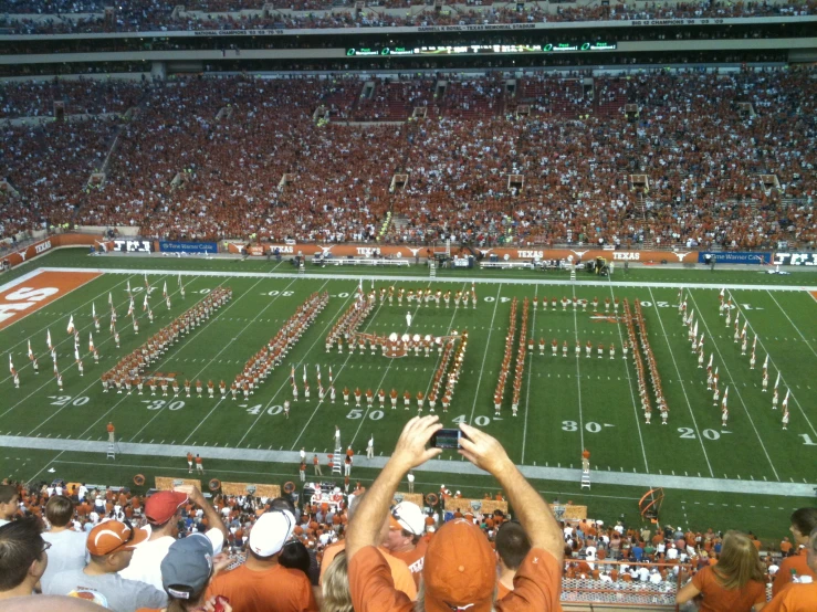 people taking pictures of the field at an event