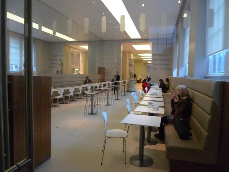 two people sitting at benches in a museum