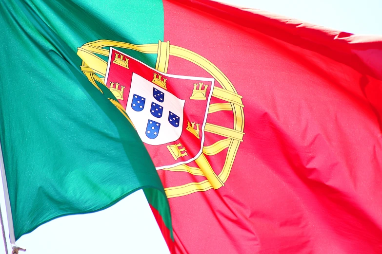 portugal flag blowing in the wind on a cloudy day